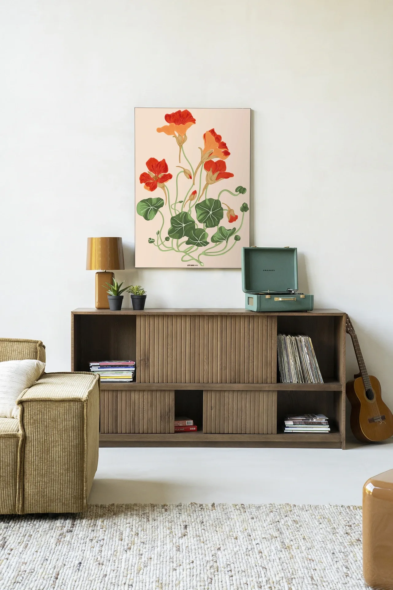 Wandkleed La Cherry - Urban Cotton hangt boven een houten dressoir in een lichte woonkamer