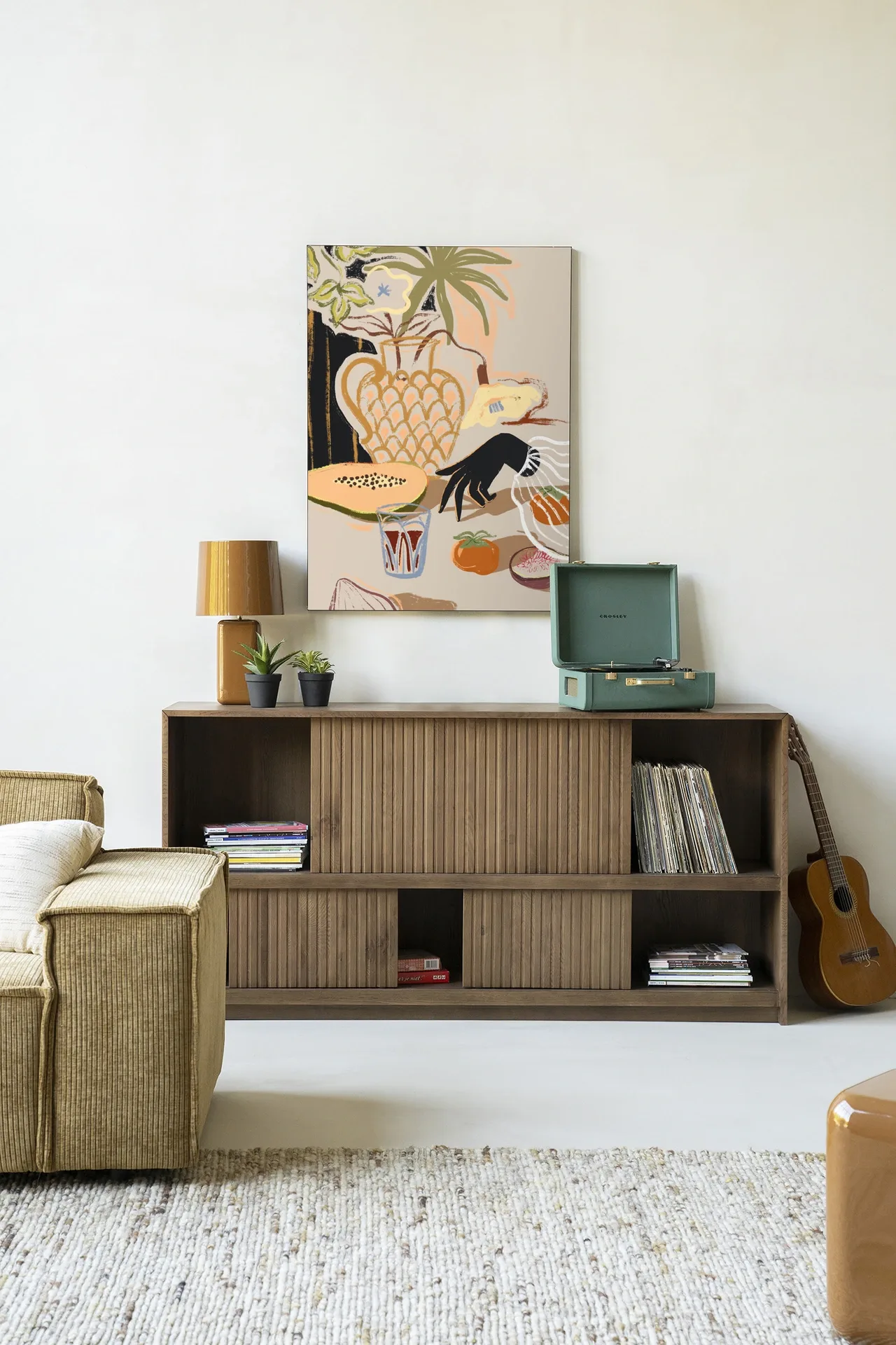 Wandkleed Fruitful Spread - Urban Cotton hangt boven een houten dressoir in een lichte woonkamer