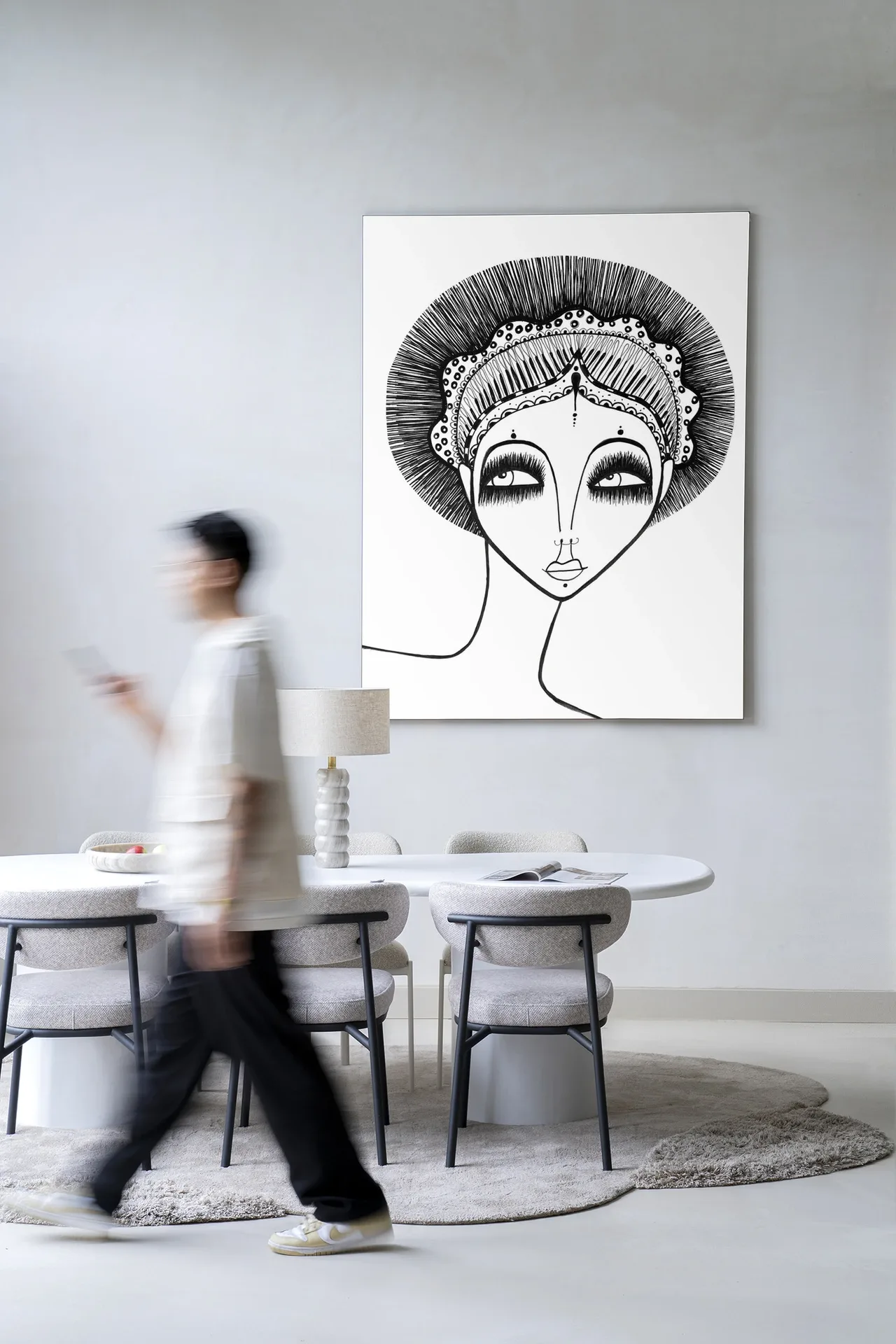 Wandkleed Leyla - Urban Cotton hangend in een modern interieur boven een eettafel met stoelen