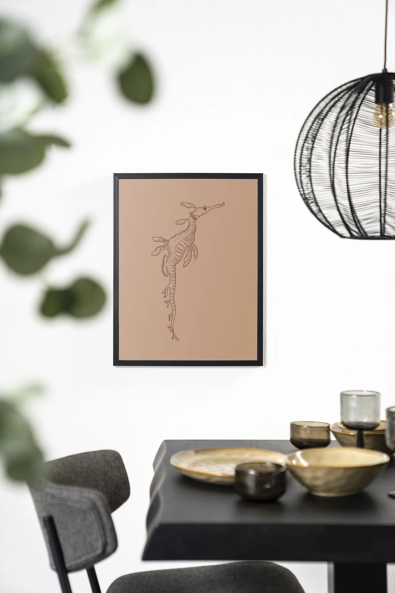 Wandteppich Lau Lau hängt an einer weißen Wand über einem schwarzen Esstisch mit goldenen Schalen - Urban Cotton