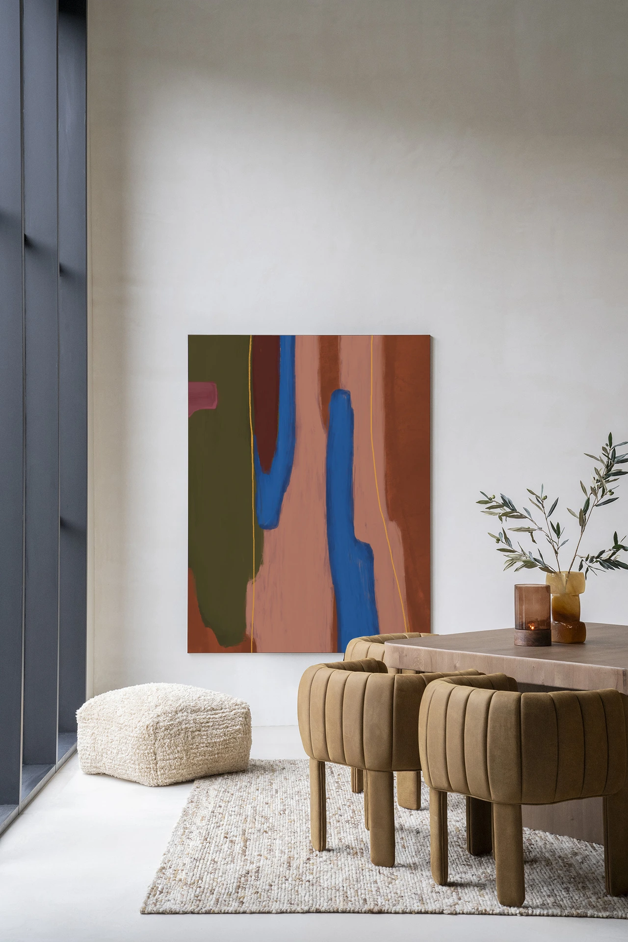 Wandkleed Tajo - Urban Cotton hangt aan een witte muur in een modern interieur met een eettafel en stoelen