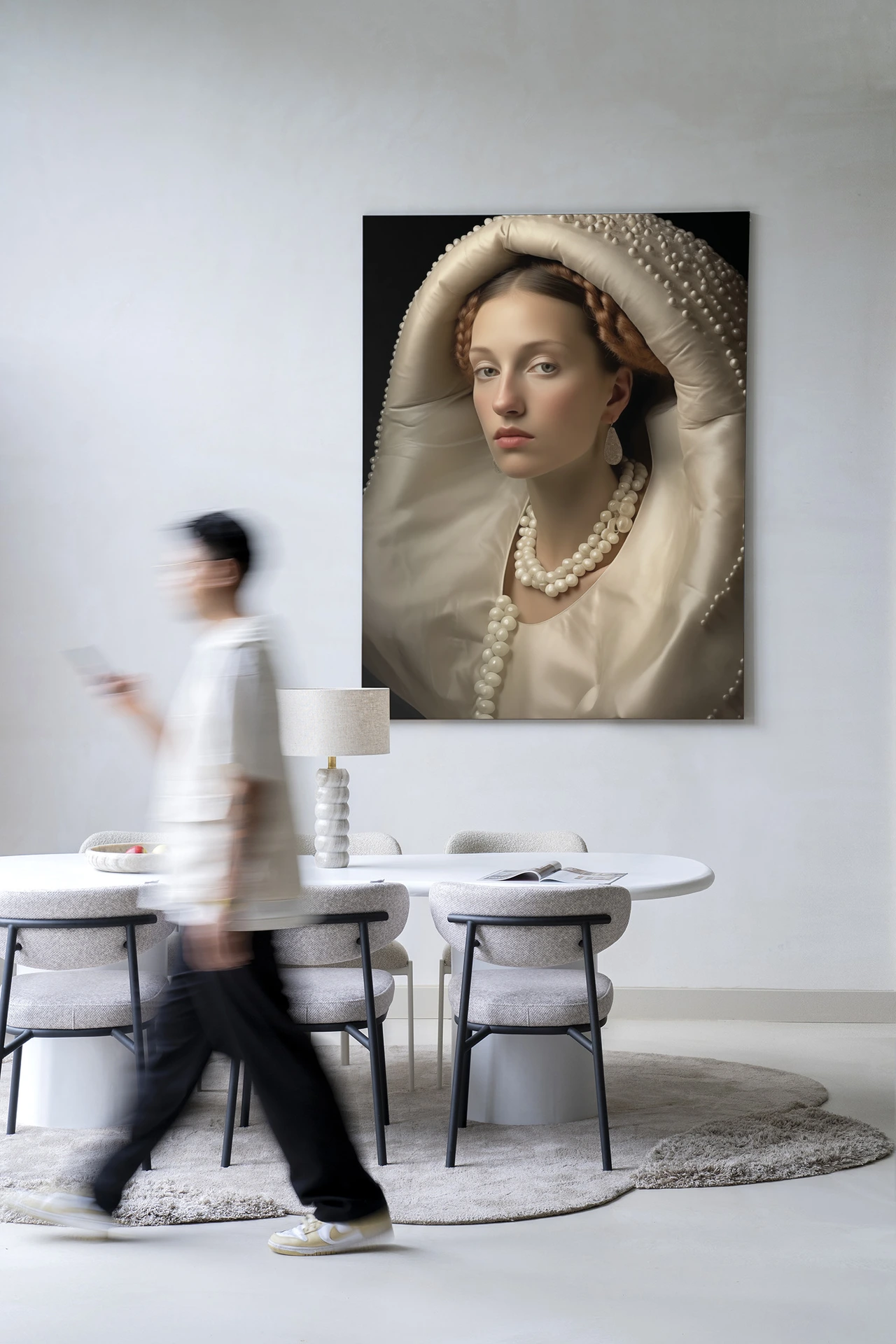 Wandkleed Queen of Pearls - Urban Cotton hangt aan een witte muur boven een eettafel