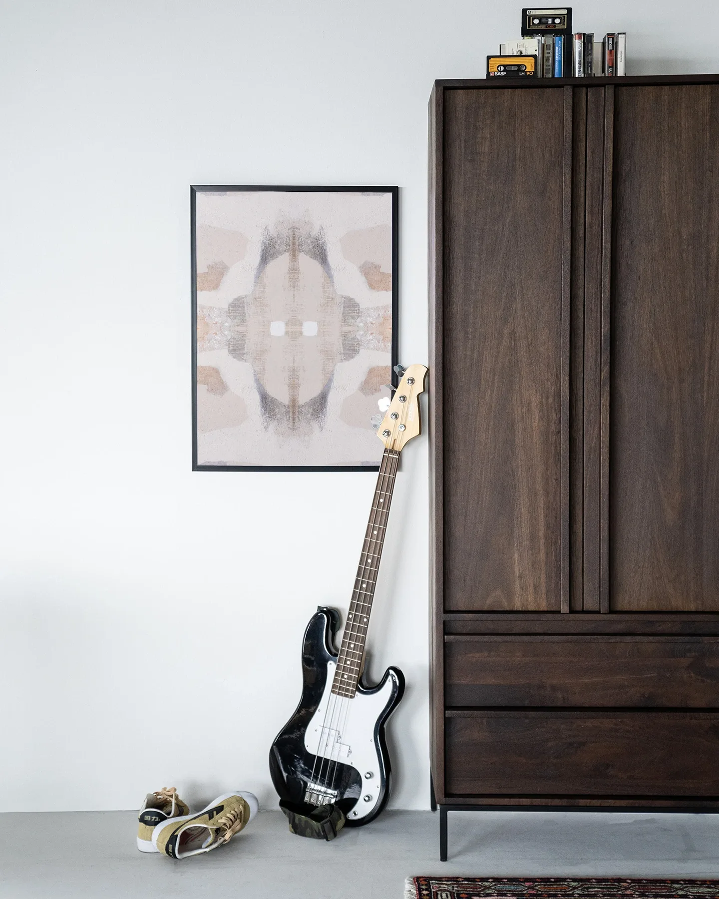 Wandkleed Chiru Antelope hangt aan een witte muur boven een basgitaar en sneakers - Urban Cotton