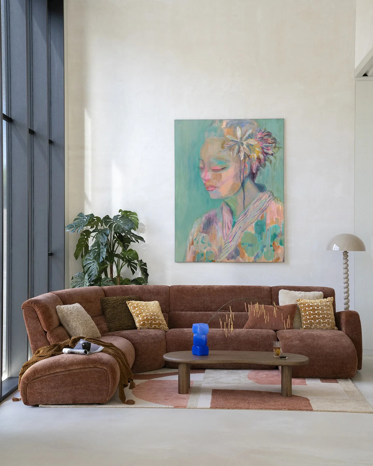 Wandkleed Calm - Urban Cotton hangt boven een bruine ribfluwelen bank in een lichte woonkamer