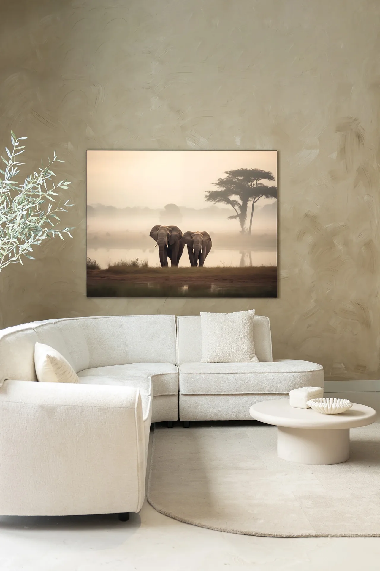 Wandteppich Elephant Mother - Urban Cotton in einem stimmungsvollen Wohnzimmer über einem weißen Sofa