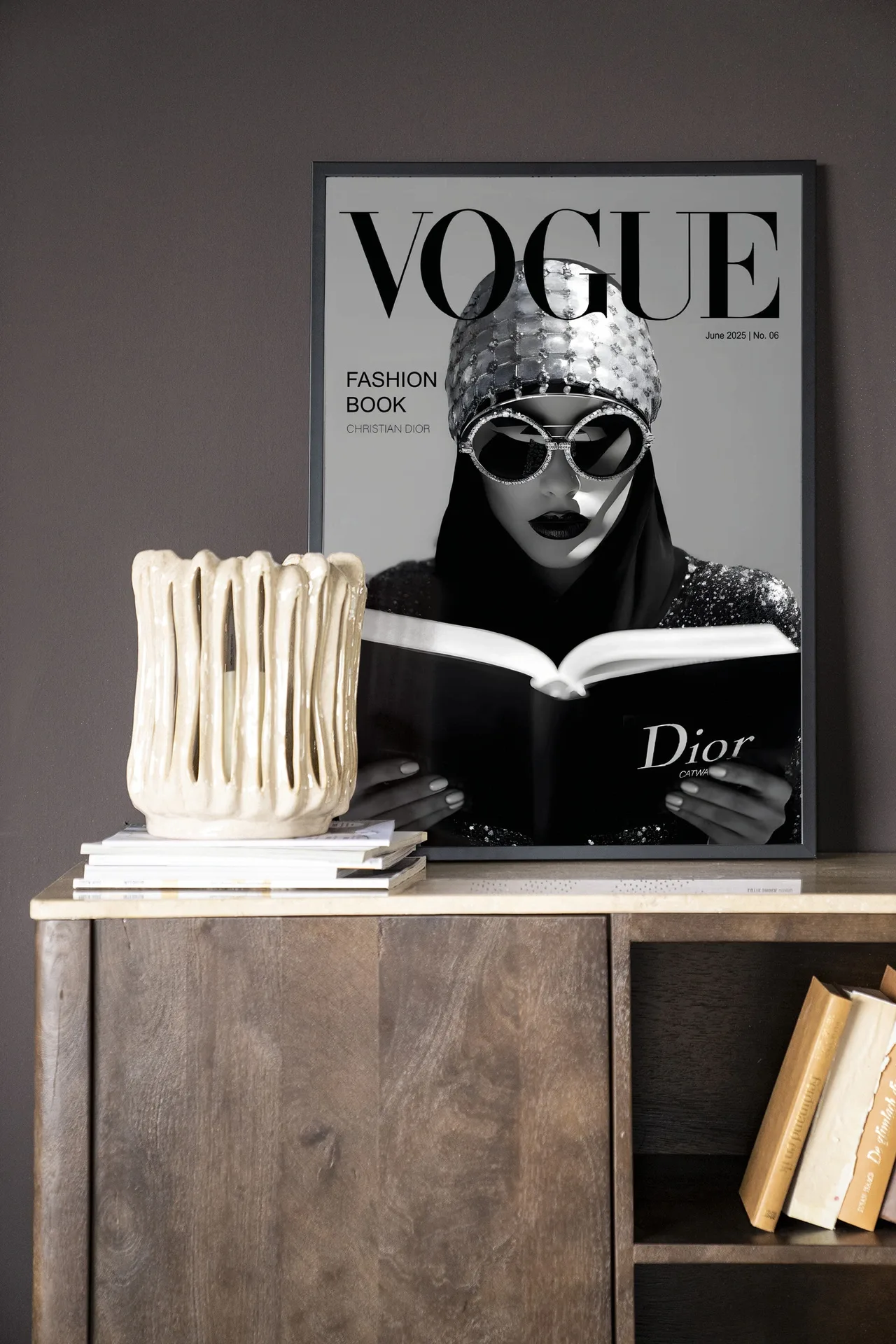 Wandteppich Fashion Book White - Urban Cotton in einem Rahmen, auf einem Holzschrank mit Büchern und einer Vase stehend
