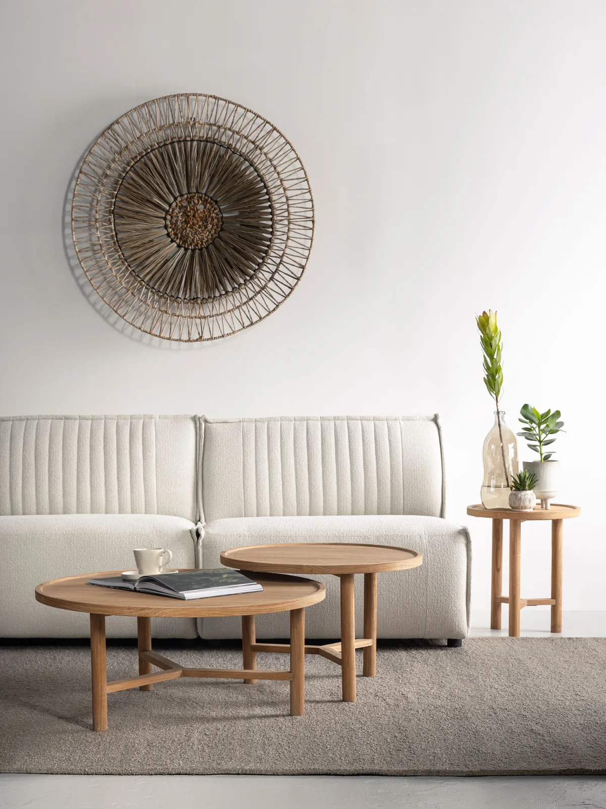 Runder Couchtisch Forte in einem hellen Wohnzimmer mit Sofa, Teppich und Dekoration - DTP Home