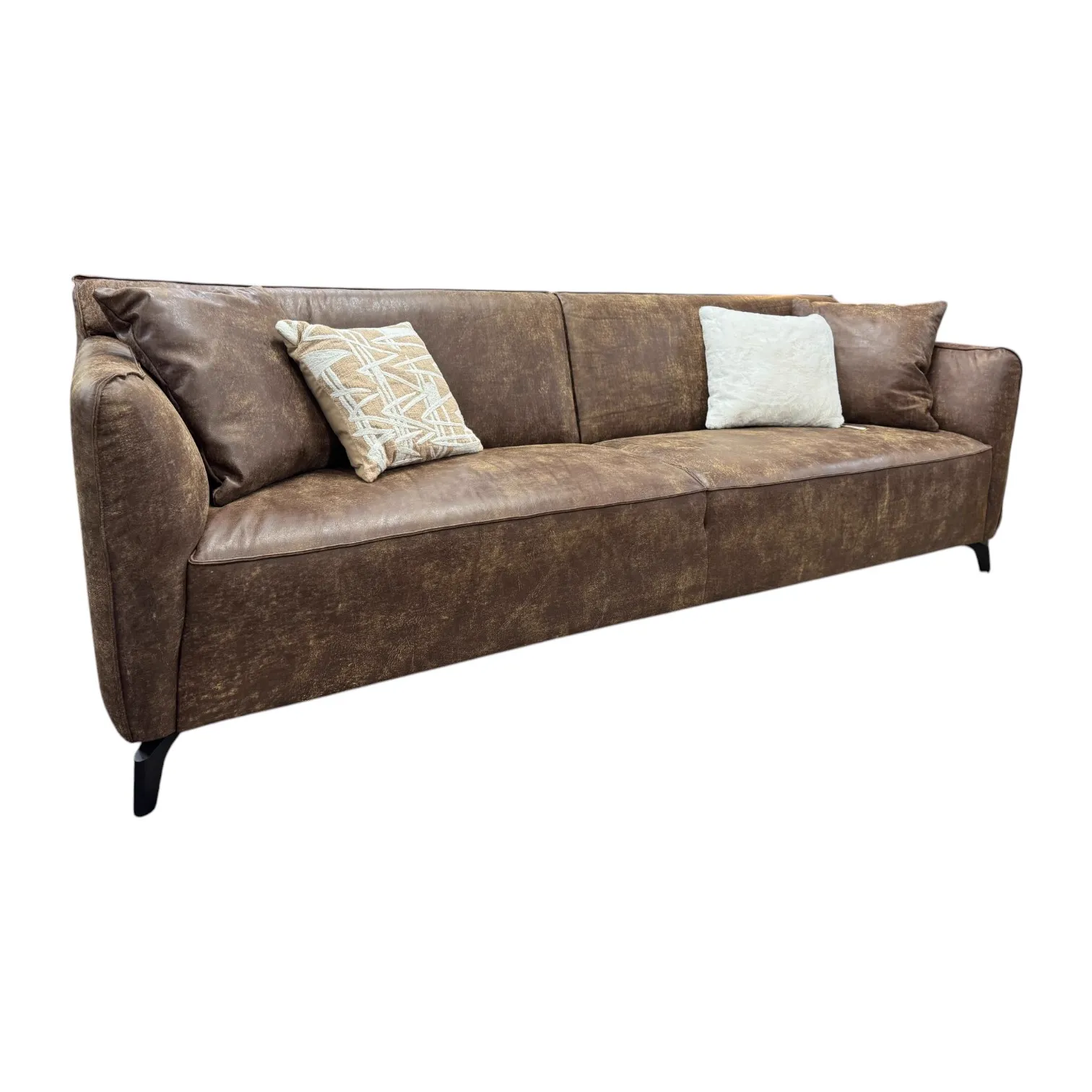 Sofa Globe Africa Leder auf weißem Hintergrund, schräg von vorne fotografiert mit zwei Zierkissen - Zitform