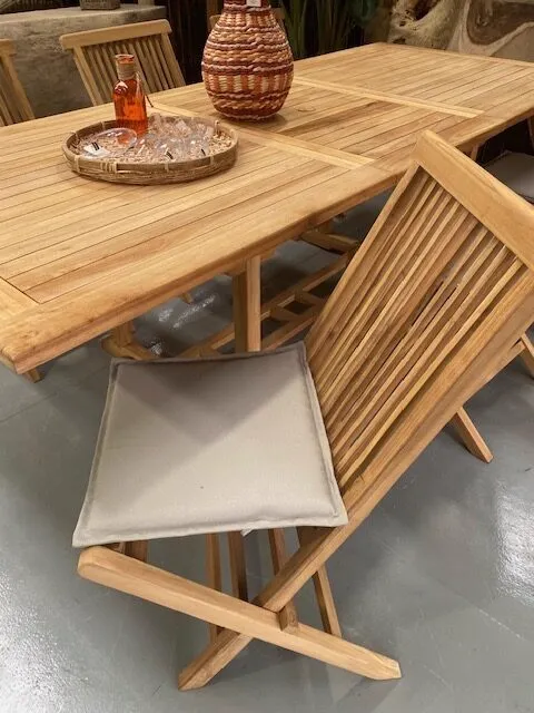Ausziehbarer Esstisch Teak mit sechs Stühlen, ein Stuhl mit Kissen im Vordergrund - Mokana Furniture