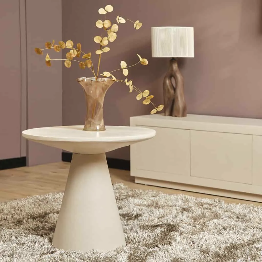 Der Couchtisch Bellis, 60 cm, steht in einem Wohnzimmer mit einer Vase mit Ästen und einer Lampe - Starfurn