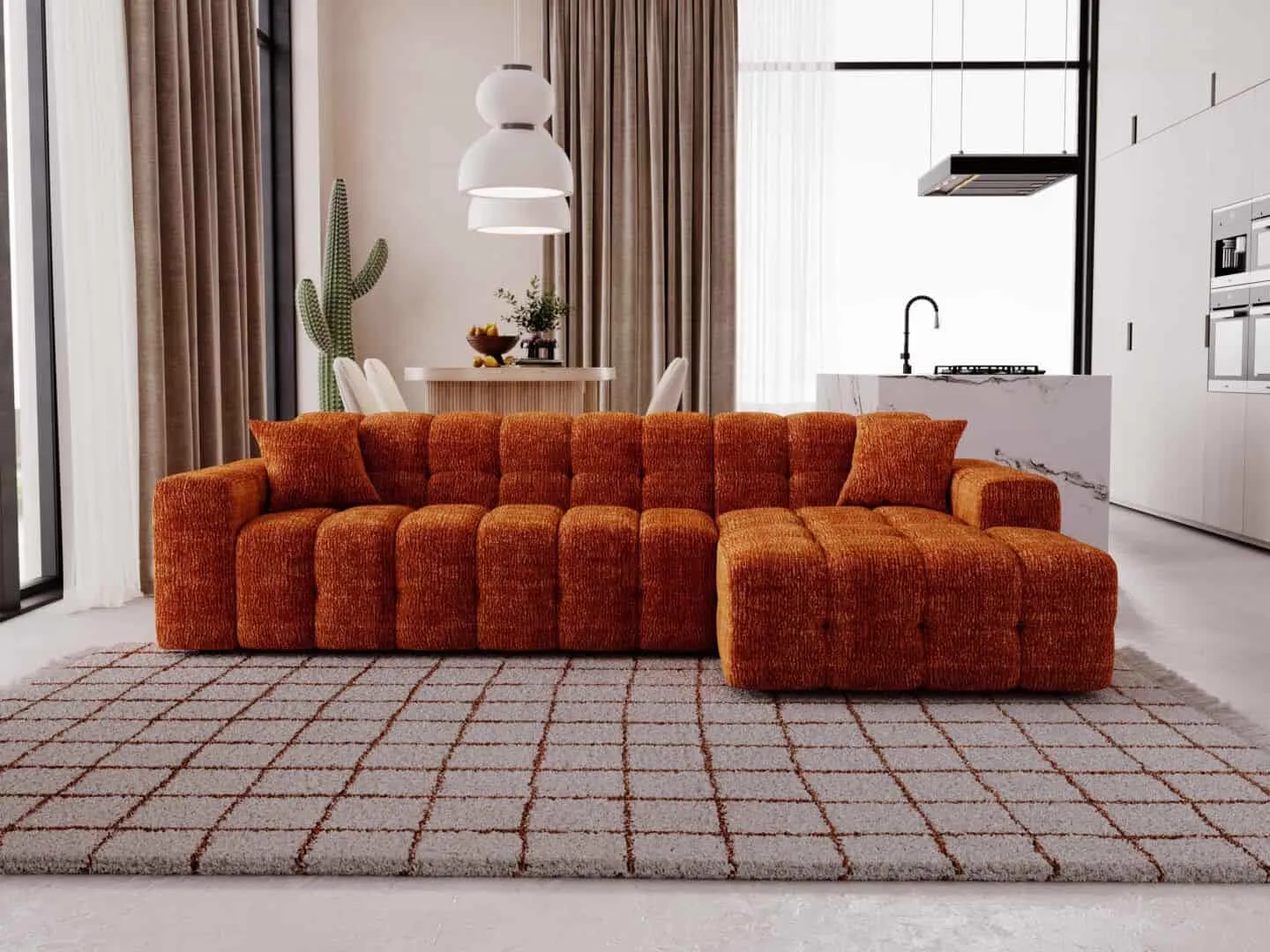 Loungesofa Bree in einem modernen Wohnzimmer mit einem großen Teppich und einer offenen Küche - Primavera