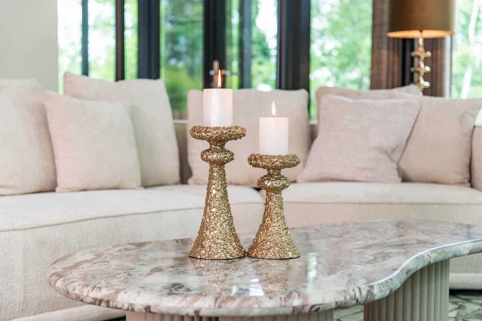 Couchtisch Coronel Blush beige mit zwei Kerzenhaltern in einem stimmungsvollen Wohnzimmer - Richmond Interiors