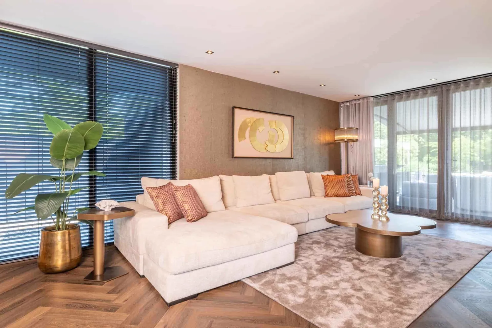 Stehleuchte Nadine bronze in einem modernen Wohnzimmer mit großem Sofa und Holzboden - Richmond Interiors