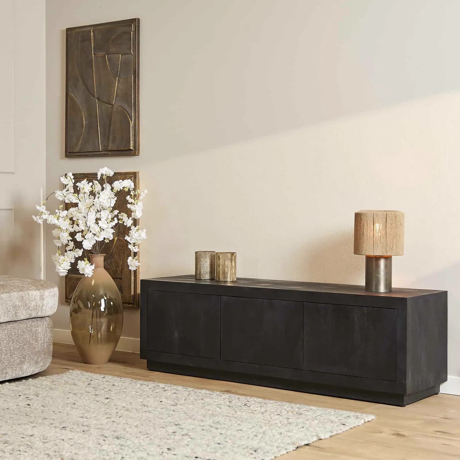 Starfurn TV-Schrank Brüssel Black 150 cm in einem stimmungsvollen Wohnzimmer mit abstrakter Kunst und einer Blumenvase