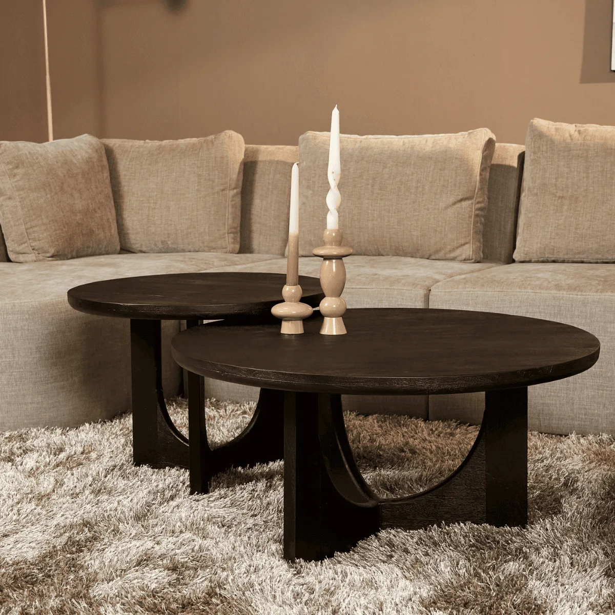 Couchtisch Guus schwarz in einem Wohnzimmer mit zwei Kerzen auf einem Hochflorteppich - Starfurn