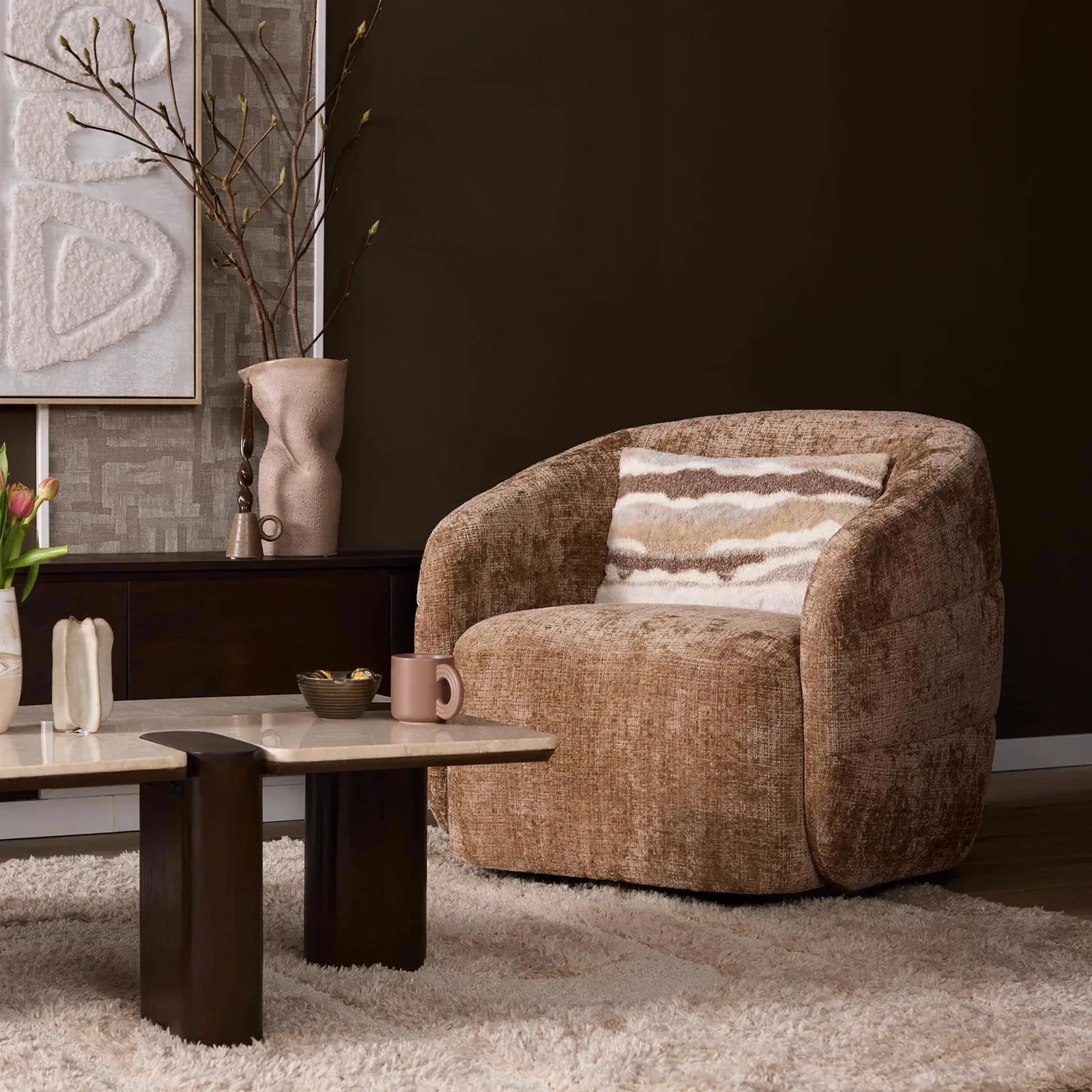 Drehbarer Sessel Yara Cinnamon in einem stimmungsvollen Wohnzimmer mit Couchtisch und Teppich - Starfurn