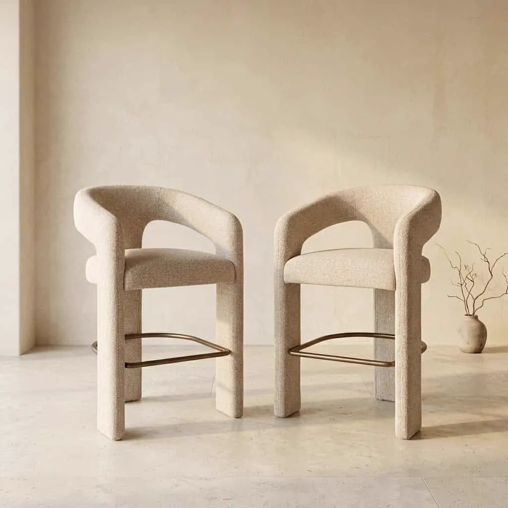 Twee Counterstoel Belle biscotti stoelen in een lichte studio-opstelling met een vaas en takken - Richmond Interiors