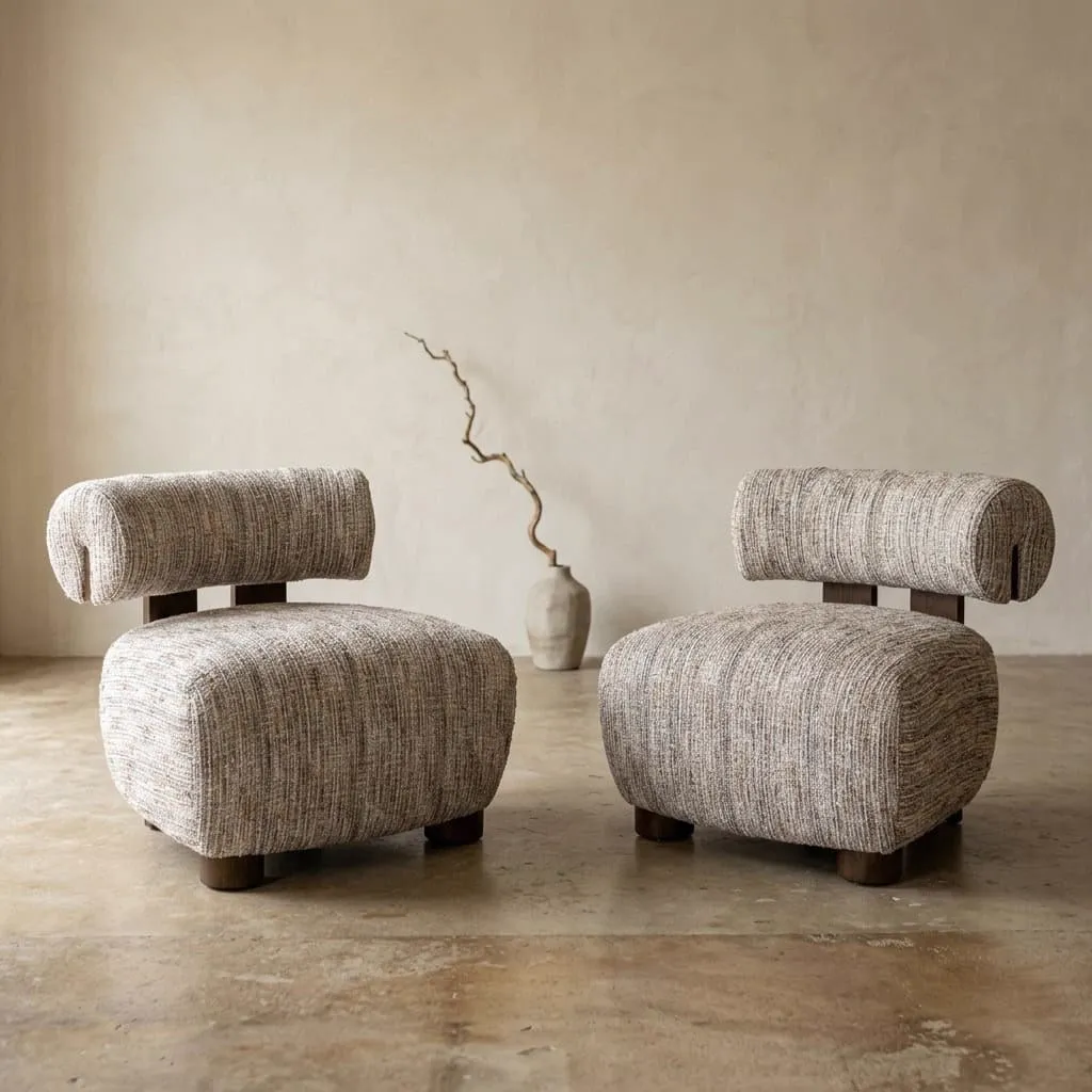 Twee Lounge stoelen Arabella greige coco in een studio met een vaas en tak op de achtergrond - Richmond Interiors