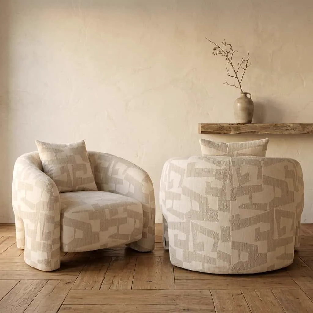 Twee lounge stoelen Tuscany beige graffic in een studio-opstelling met houten vloer en een plank aan de muur - Richmond Interiors